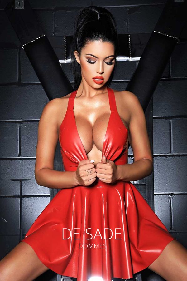 Amanda showing off some cleavage while wearing a latex red dress 